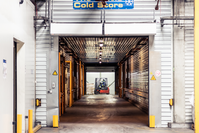 The front of the cold store warehouse in Riga. The gate is open and forklift can be seen in the background.