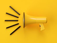 Yellow megaphone on a yellow background.