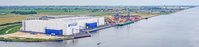 Aerial view of warehouse buildings located directly along the waterfront.
